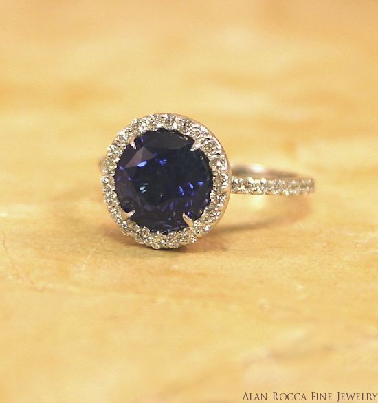 Round Blue Sapphire Surrounded by a Halo of Prong Set Round Cut Diamonds