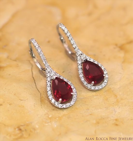 Pear Shaped Ruby Drop Earrings Surrounded by Prong Set Round Diamonds